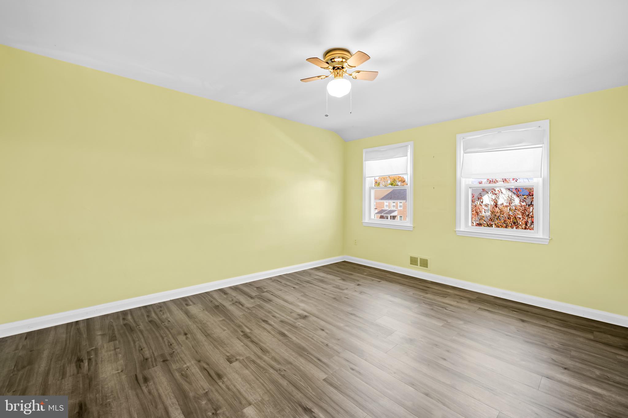 1027 Evesham Avenue Baltimore, MD 21212 - Photo 24 of 39 an empty room with a window and wooden floor