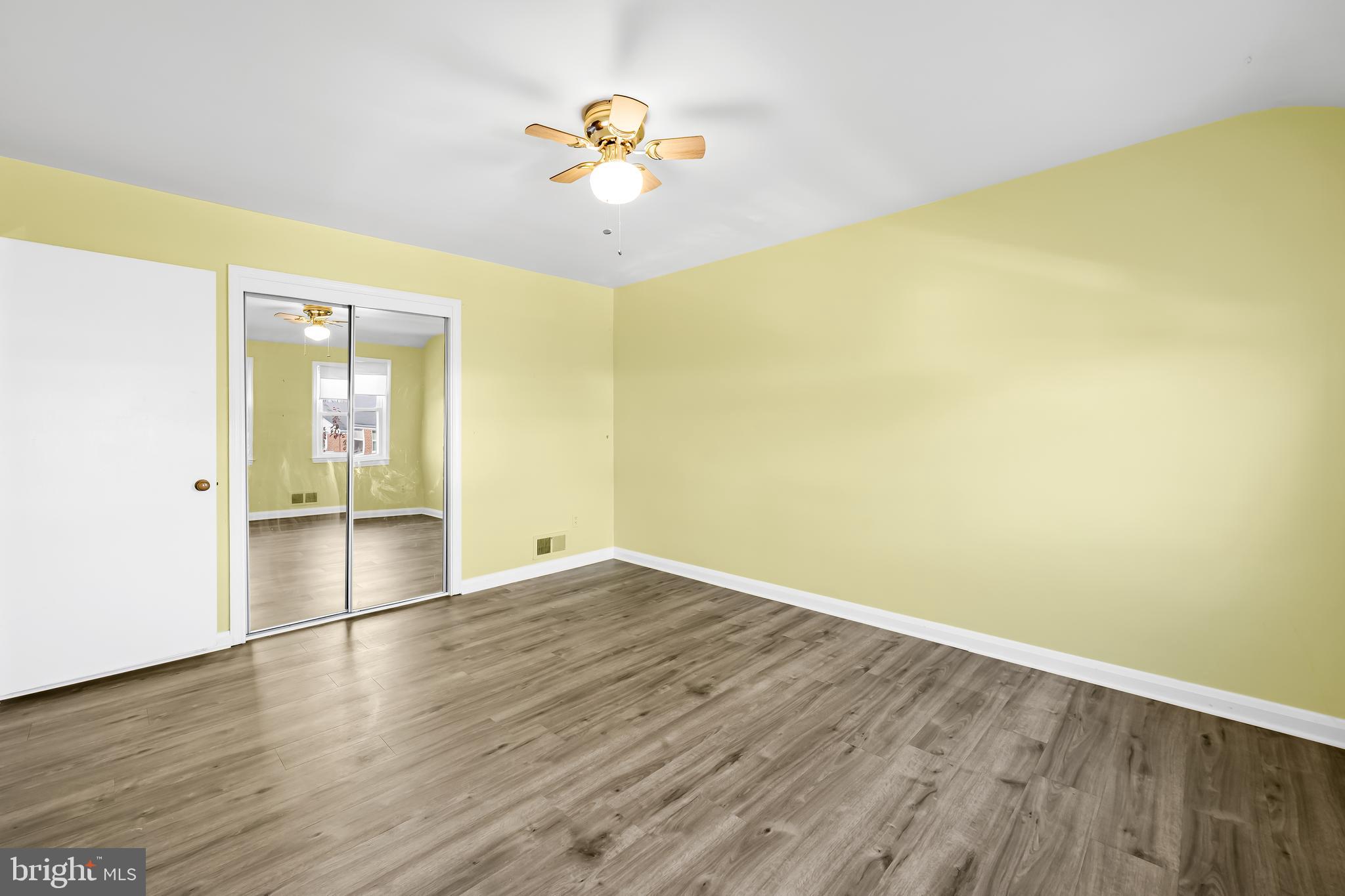 1027 Evesham Avenue Baltimore, MD 21212 - Photo 26 of 39 an empty room with wooden floor and natural light