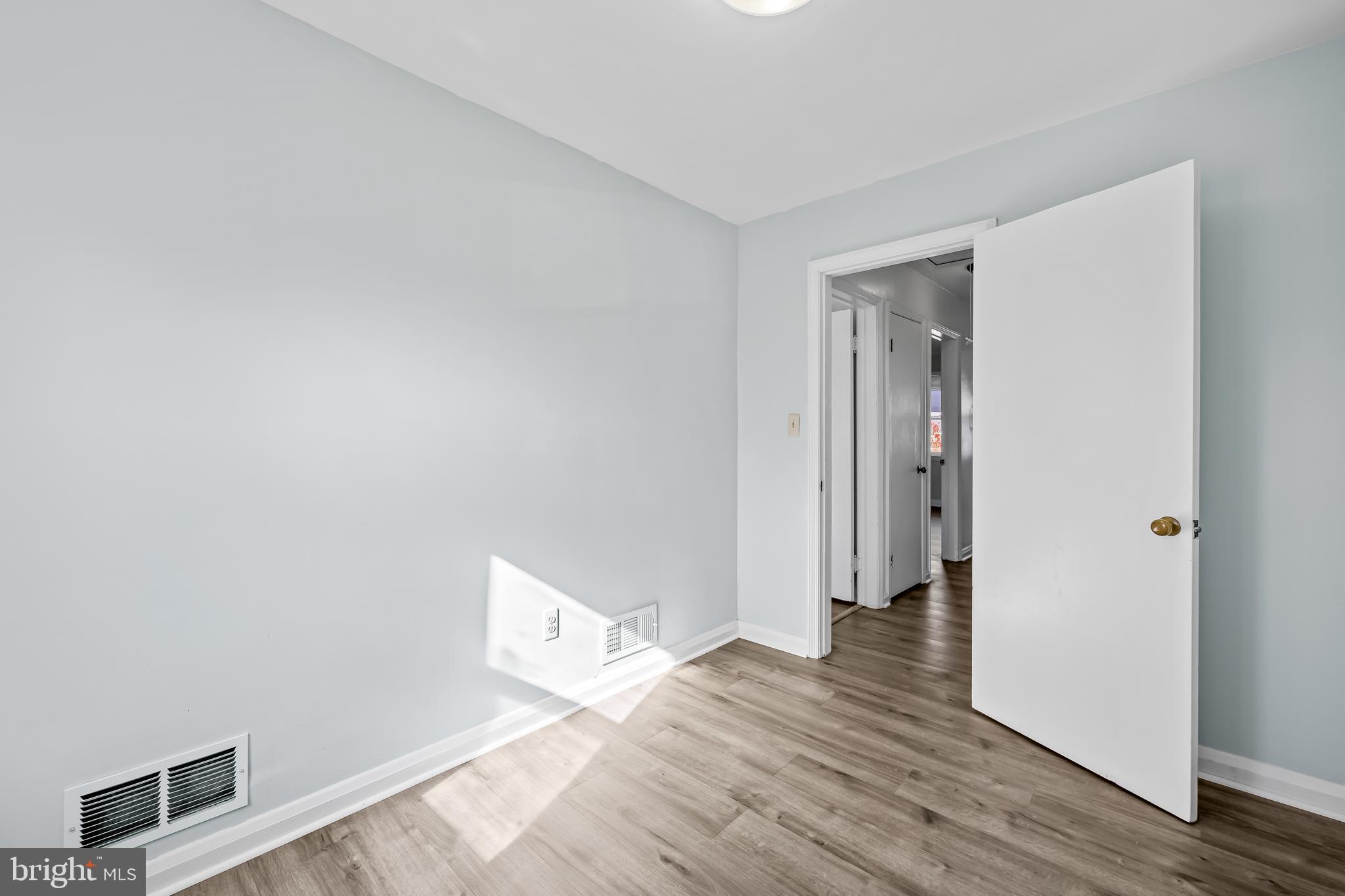 1027 Evesham Avenue Baltimore, MD 21212 - Photo 30 of 39 a view of an empty room with wooden floor and closet
