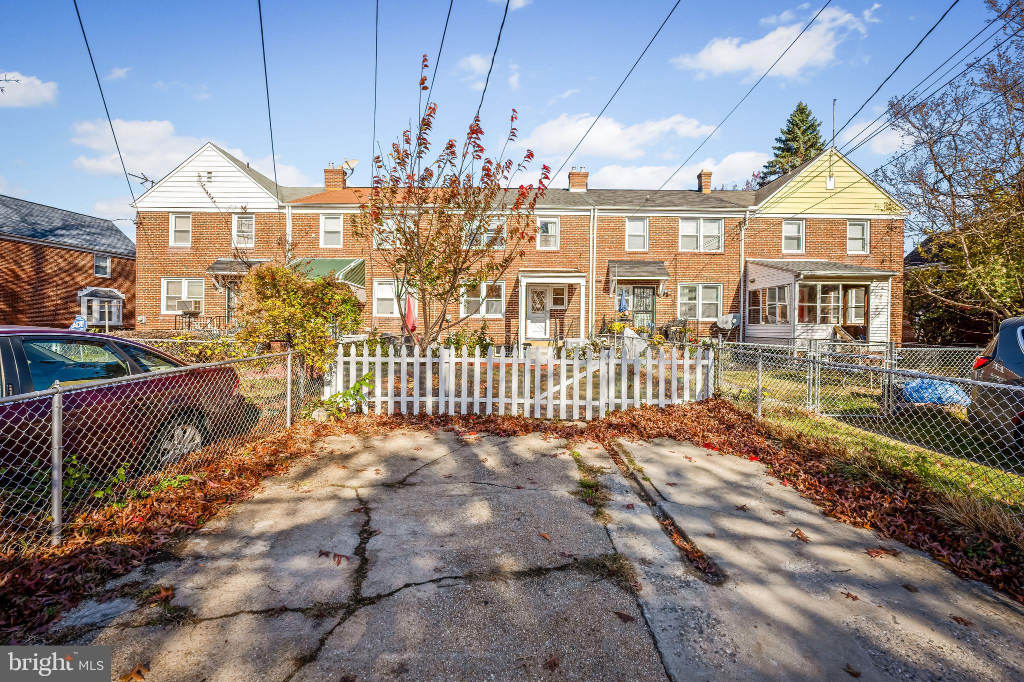 1027 Evesham Avenue Baltimore, MD 21212 - Photo 35 of 39 a view of a brick house with many windows next to a road