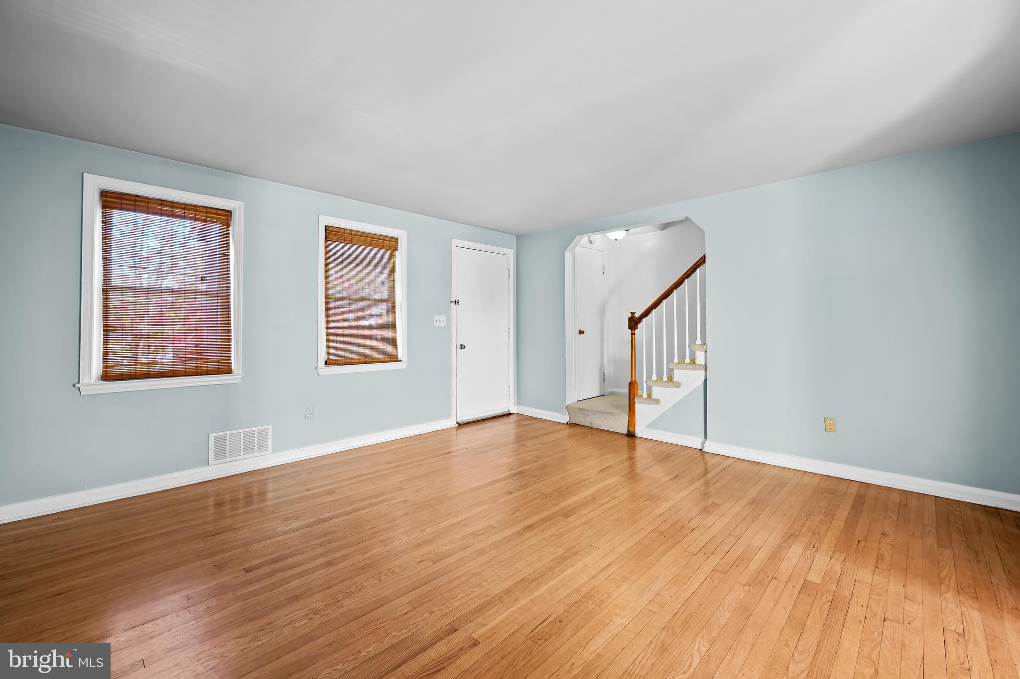 1027 Evesham Avenue Baltimore, MD 21212 - Photo 4 of 39 a view of an empty room with wooden floor and a window