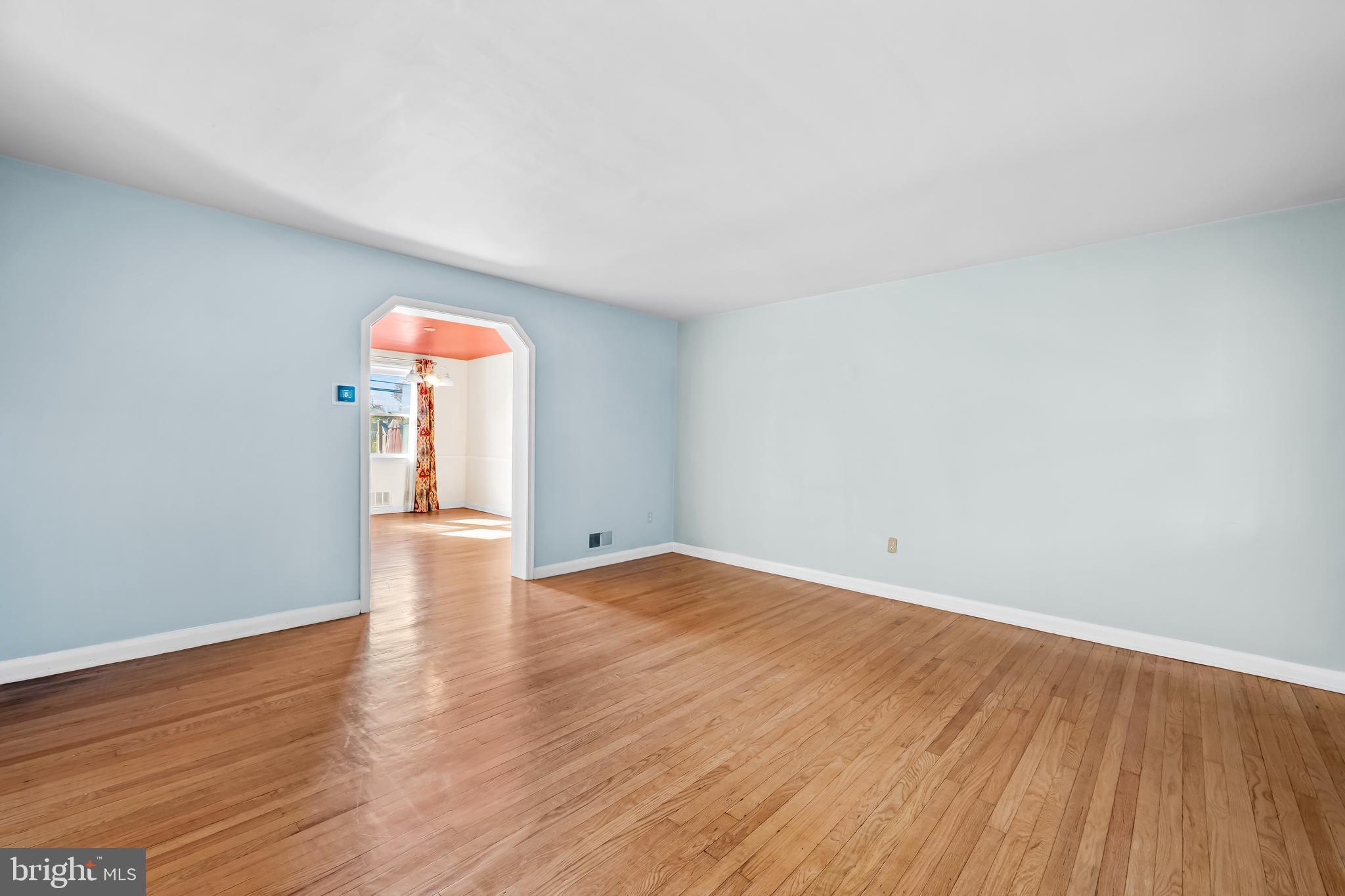 1027 Evesham Avenue Baltimore, MD 21212 - Photo 6 of 39 a view of an empty room with wooden floor and a window