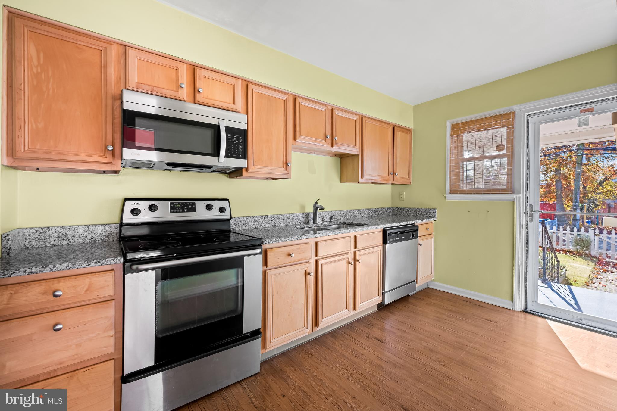 1027 Evesham Avenue Baltimore, MD 21212 - Photo 9 of 39 a kitchen with stainless steel appliances granite countertop a stove and a microwave