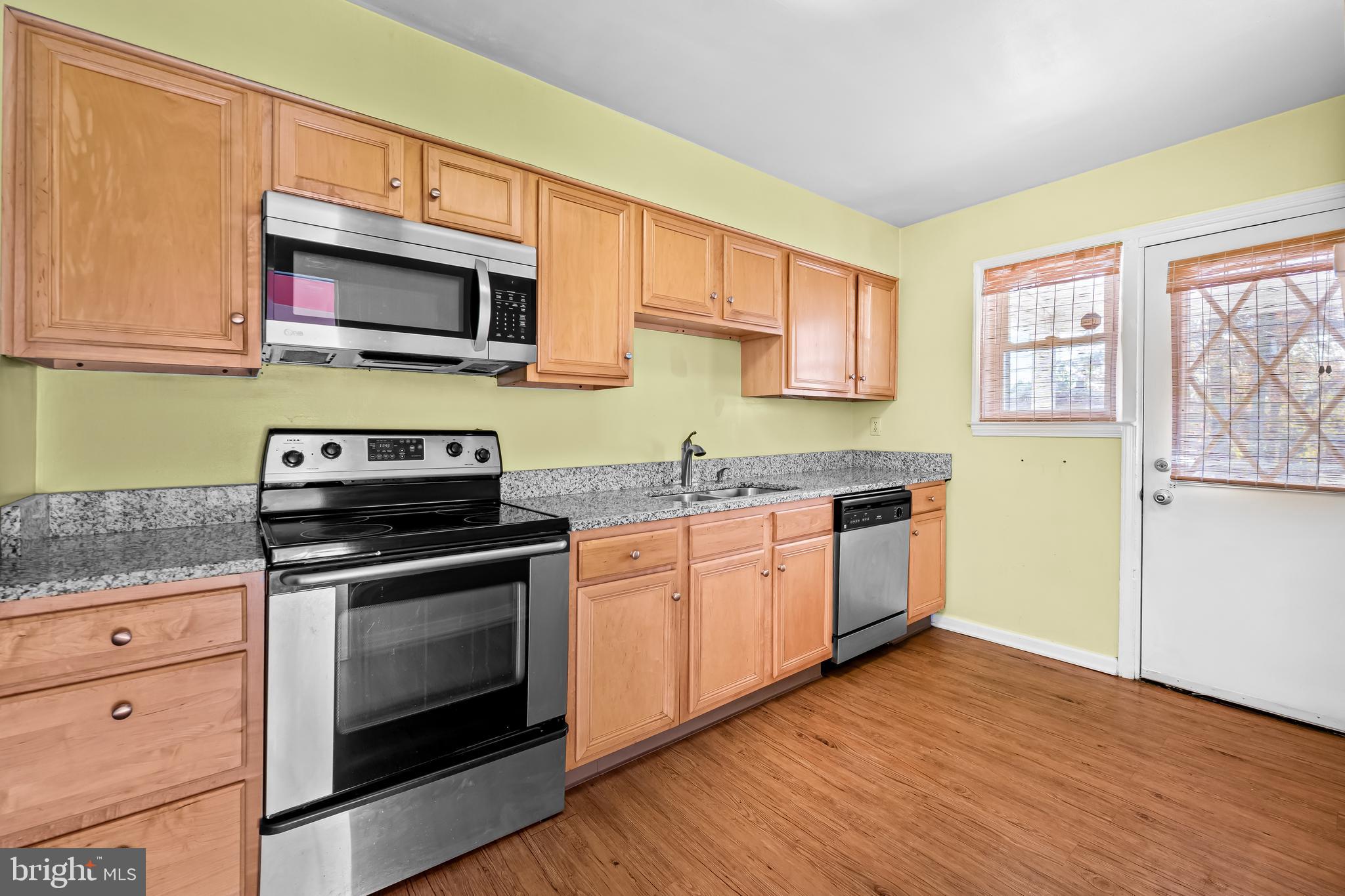 1027 Evesham Avenue Baltimore, MD 21212 - Photo 10 of 39 a kitchen with stainless steel appliances granite countertop a stove microwave and sink