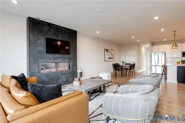 a living room with fireplace furniture and a flat screen tv