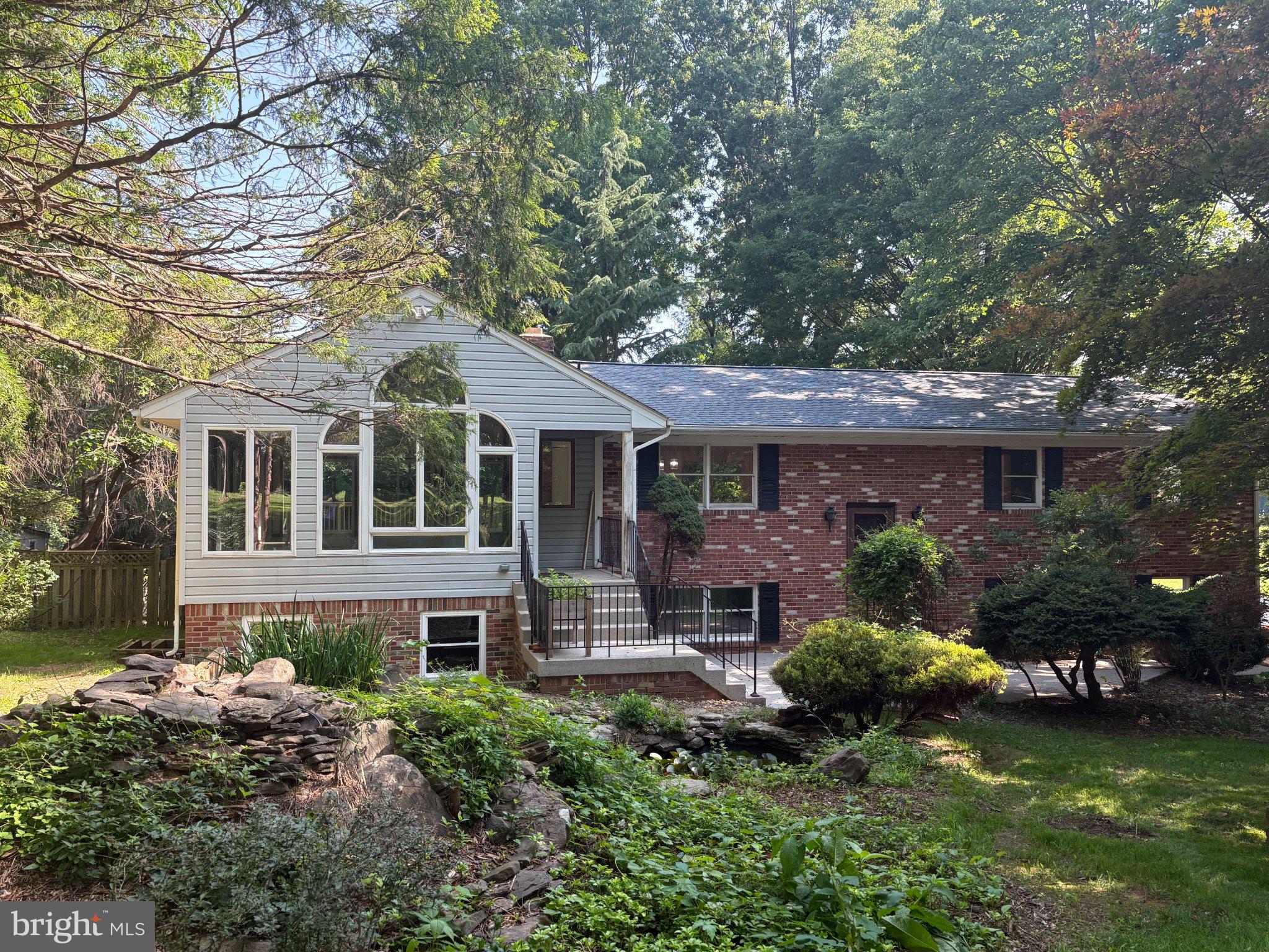 13715 Lewisdale Road Clarksburg, MD 20871 - Photo 2 of 3 Charming brick home in lush greenery.