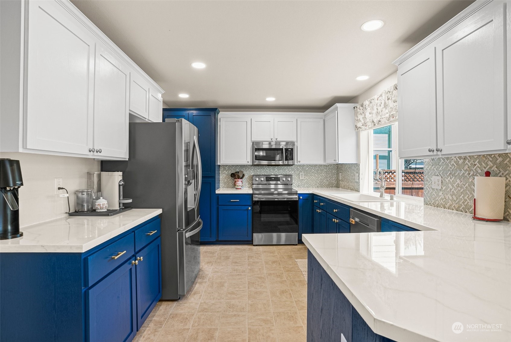 6642 Compass Street Southeast Lacey, WA 98513 - Photo 13 of 40 a kitchen with stainless steel appliances granite countertop a sink stove and refrigerator
