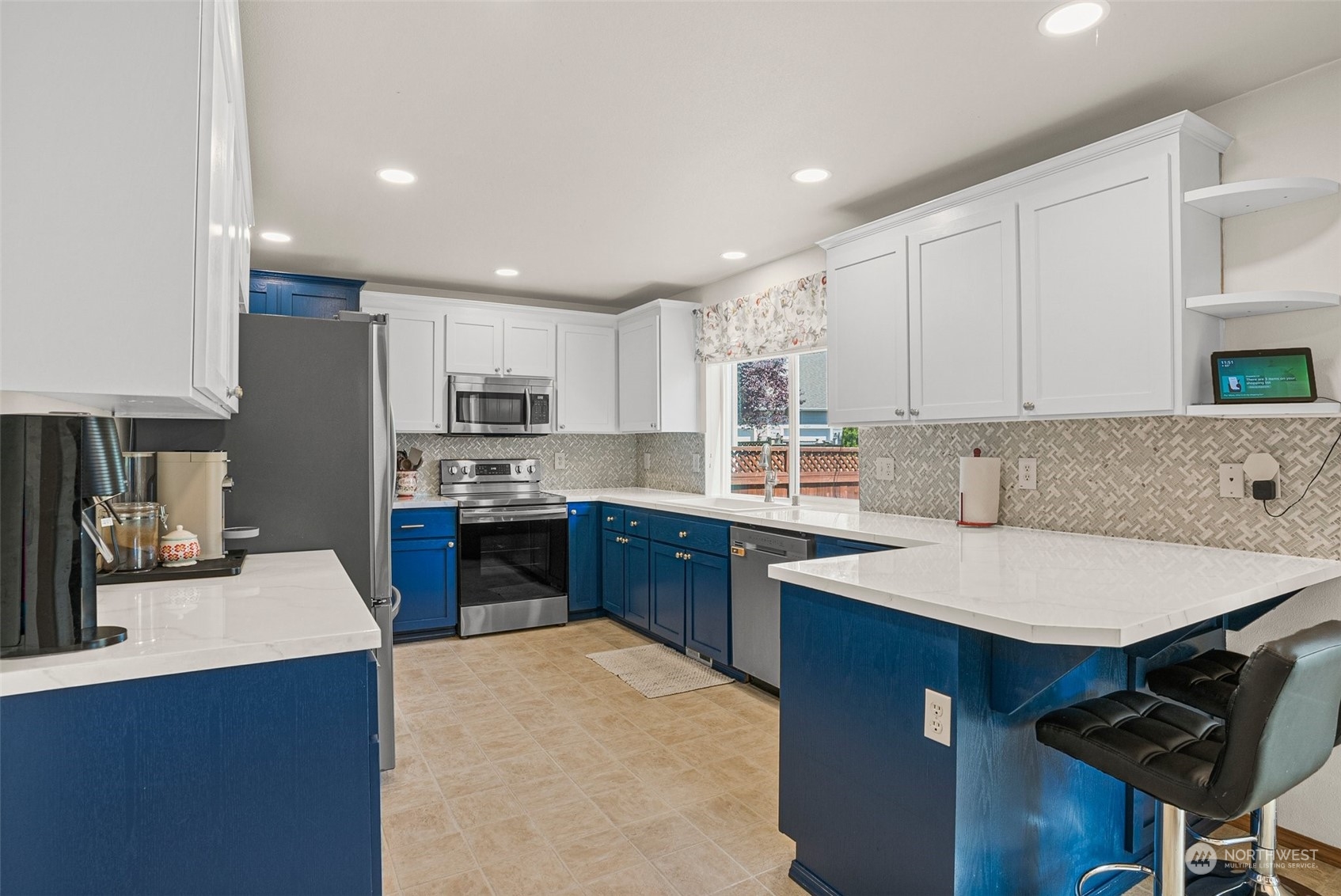 6642 Compass Street Southeast Lacey, WA 98513 - Photo 14 of 40 a kitchen with stainless steel appliances granite countertop a table chairs sink refrigerator and cabinets