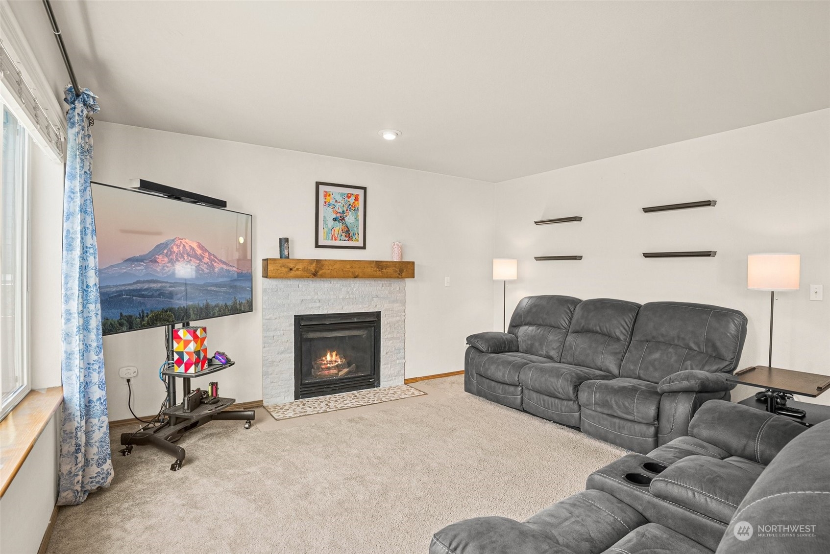 6642 Compass Street Southeast Lacey, WA 98513 - Photo 17 of 40 a living room with furniture a flat screen tv and a fireplace