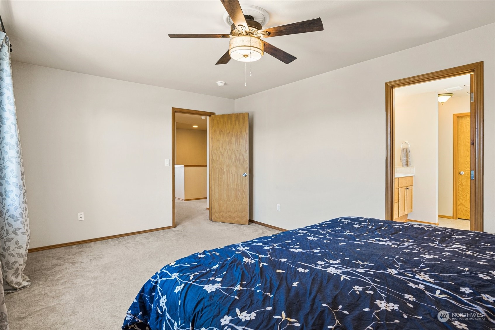 6642 Compass Street Southeast Lacey, WA 98513 - Photo 25 of 40 a bedroom with a bed and a chandelier fan