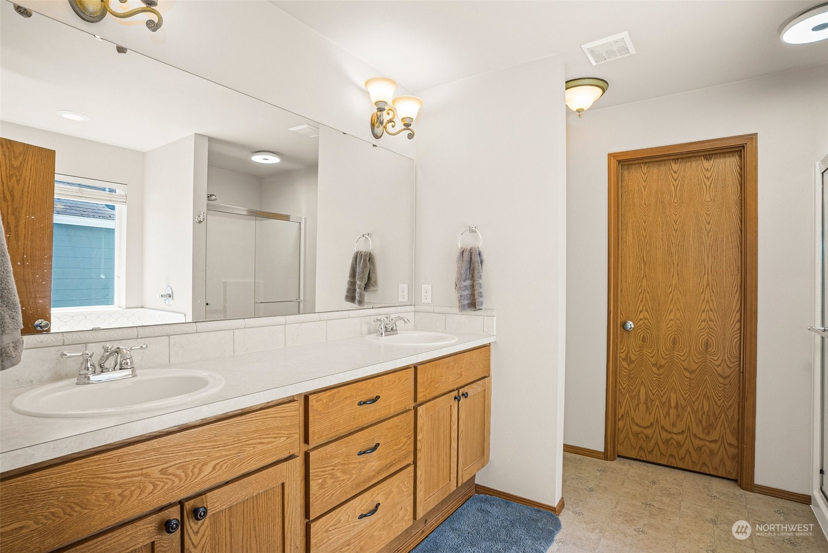 6642 Compass Street Southeast Lacey, WA 98513 - Photo 27 of 40 a bathroom with double sink and a mirror