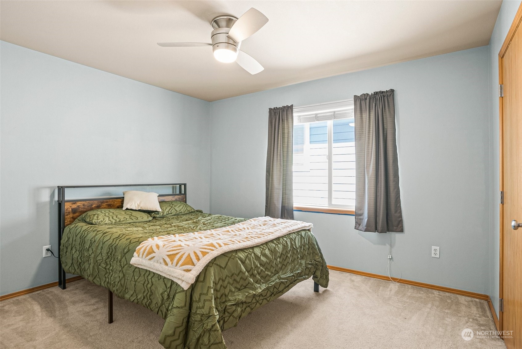 6642 Compass Street Southeast Lacey, WA 98513 - Photo 31 of 40 a bedroom with a bed a chandelier and a window