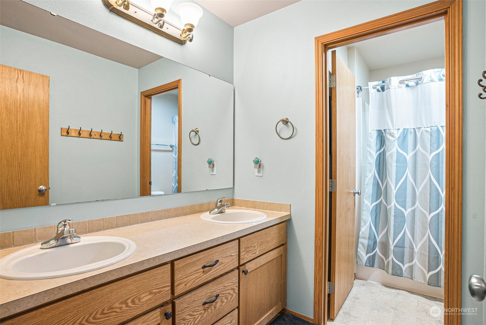 6642 Compass Street Southeast Lacey, WA 98513 - Photo 32 of 40 a bathroom with a sink and a mirror