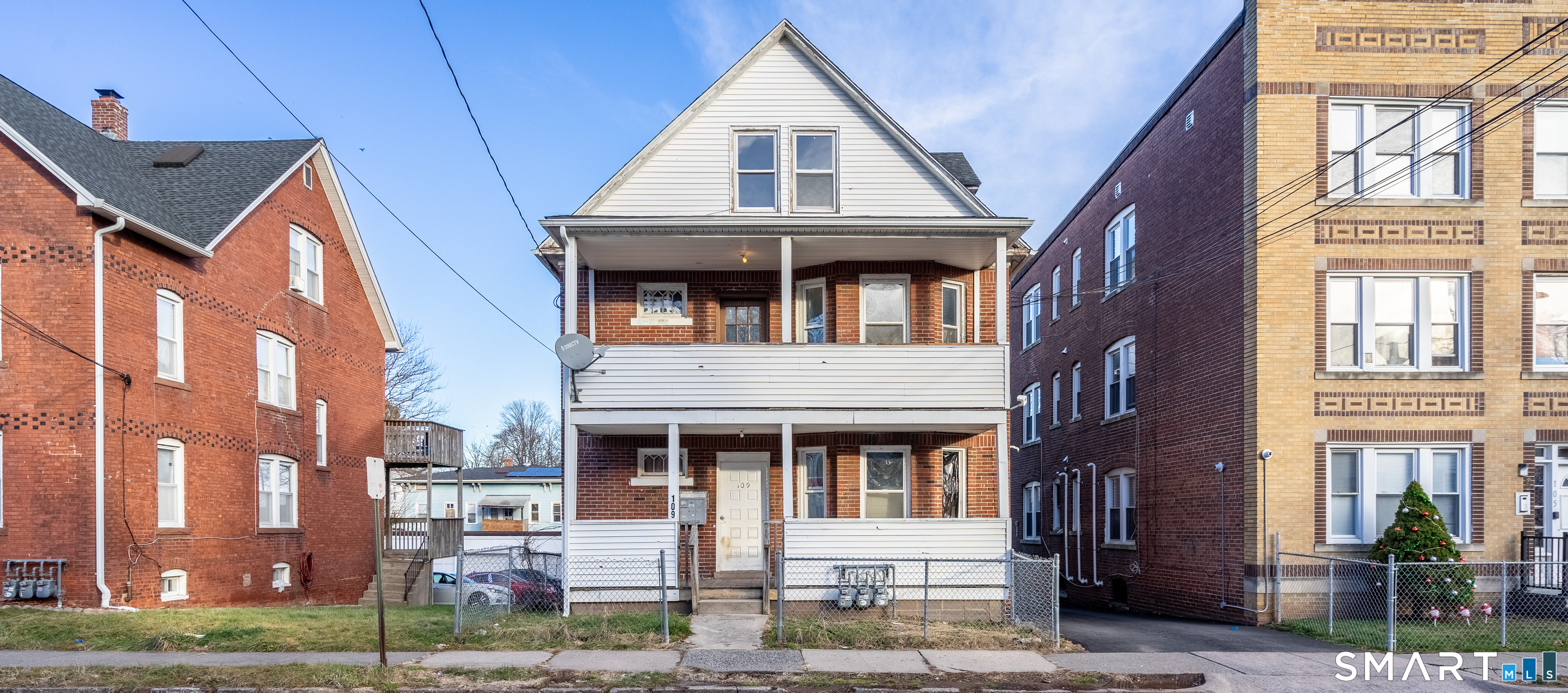 109 Clark Street New Britain, CT 06051 - Photo 2 of 24 a front view of a residential apartment building with a yard