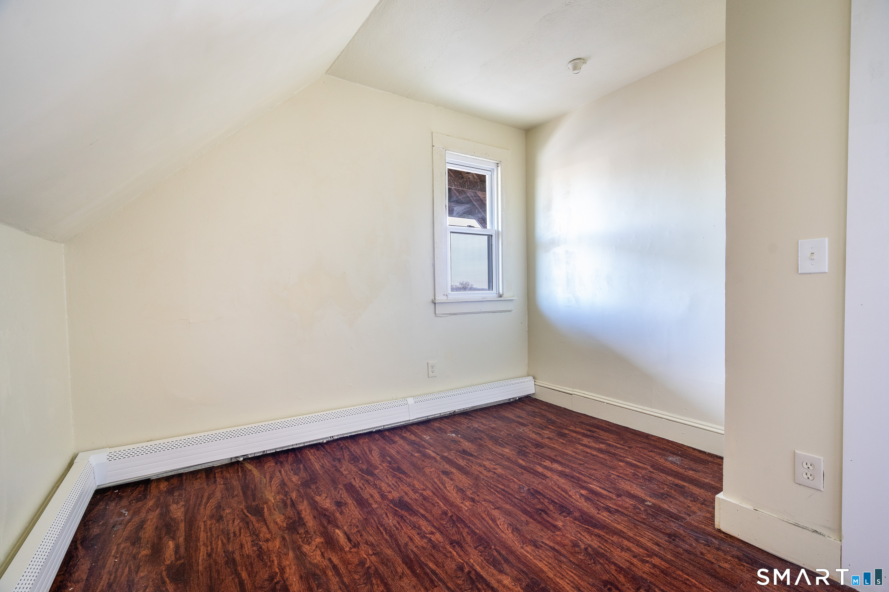 109 Clark Street New Britain, CT 06051 - Photo 21 of 24 an empty room with wooden floor and windows