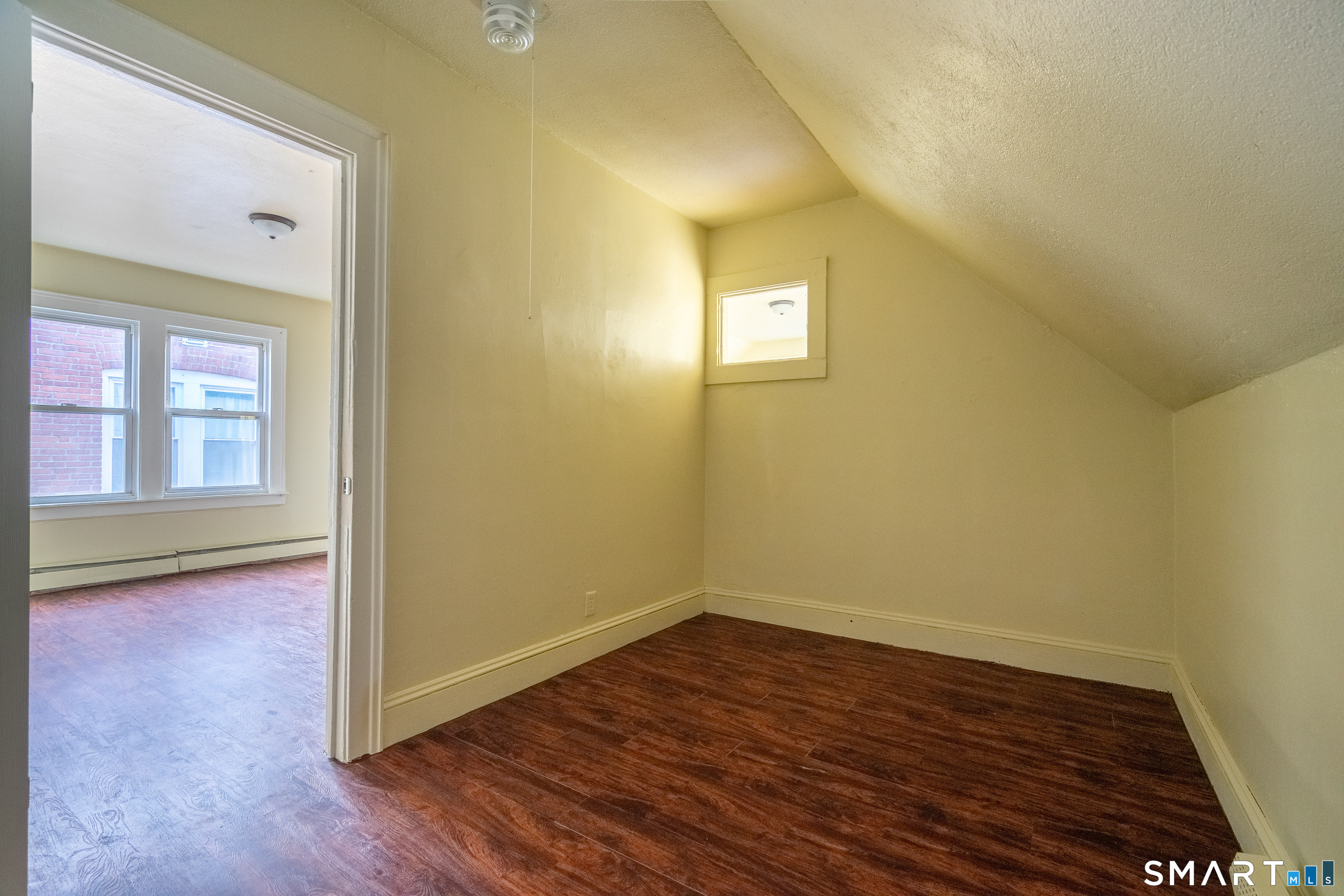 109 Clark Street New Britain, CT 06051 - Photo 24 of 24 an empty room with wooden floor and windows