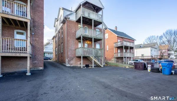 a view of a house with a yard and wooden deck