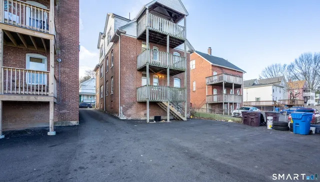 a view of a house with a yard and wooden deck