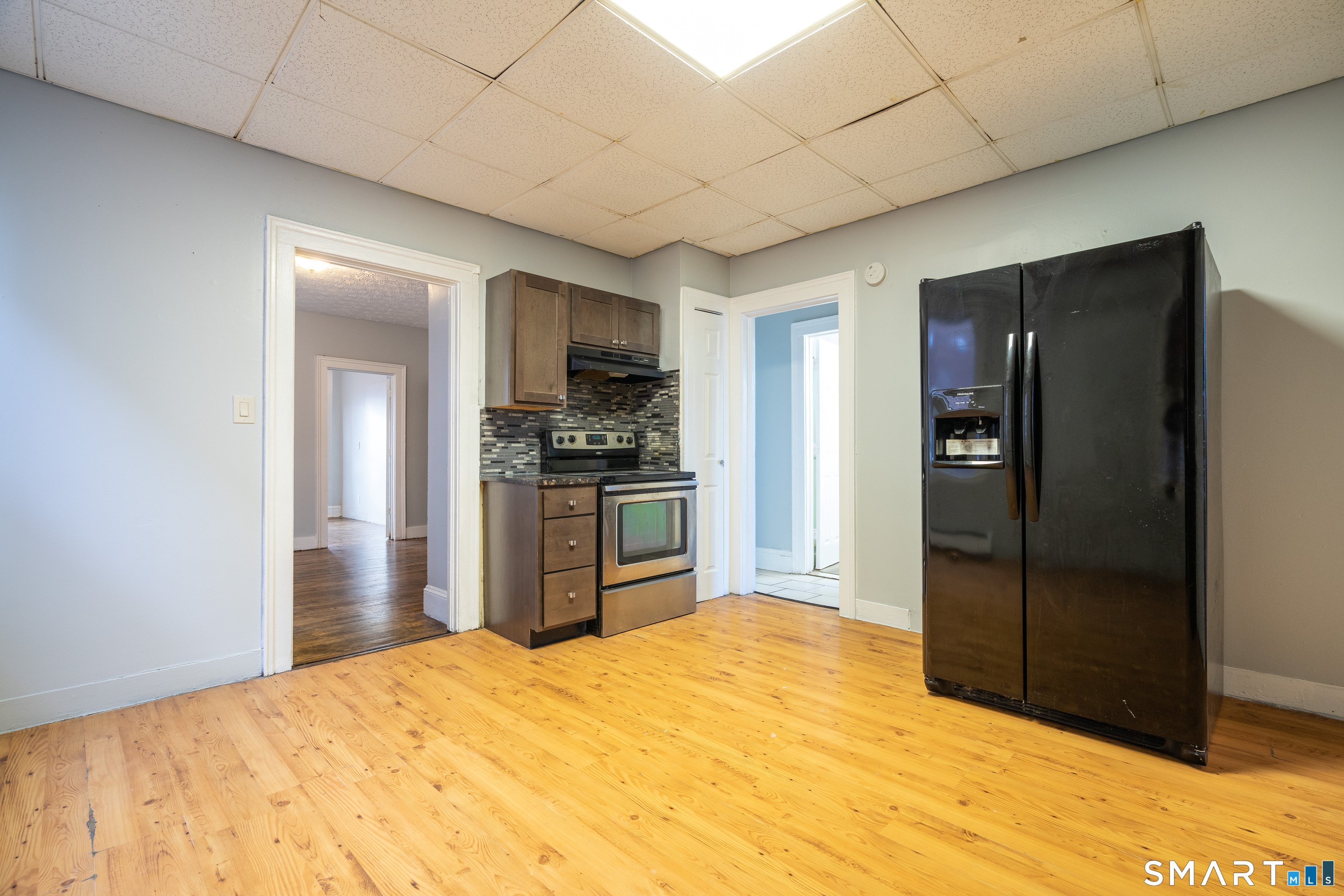 109 Clark Street New Britain, CT 06051 - Photo 10 of 24 a kitchen with stainless steel appliances kitchen island granite countertop a refrigerator and a sink