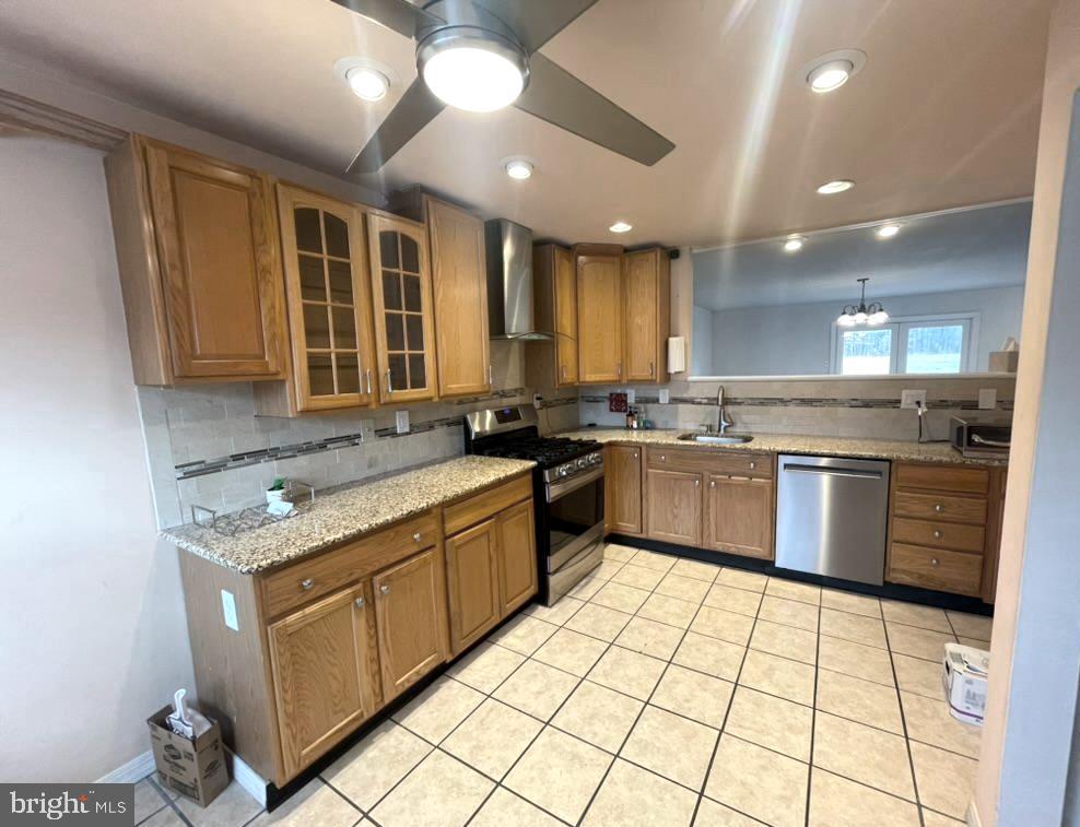 86 Louis James Court, Unit 86 Upper Chichester, PA 19014 - Photo 4 of 12 a kitchen with stainless steel appliances granite countertop a stove sink and cabinets