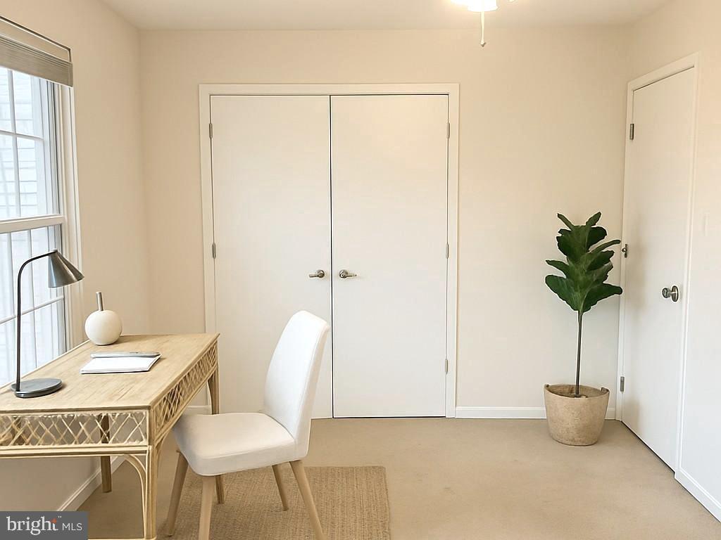 86 Louis James Court, Unit 86 Upper Chichester, PA 19014 - Photo 9 of 12 a living room with furniture a potted plant and a window