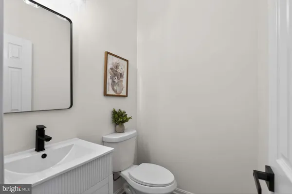 a bathroom with a sink mirror and toilet