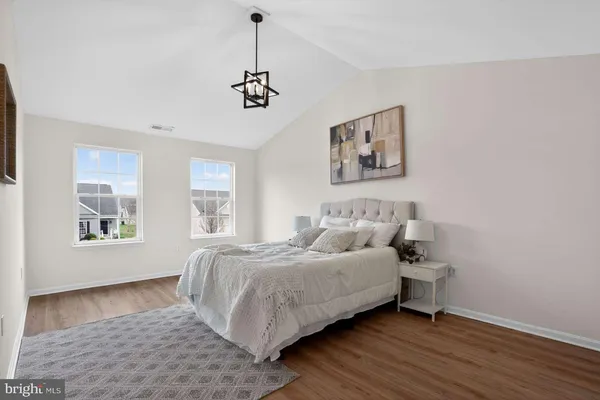 a spacious bedroom with a bed and a window