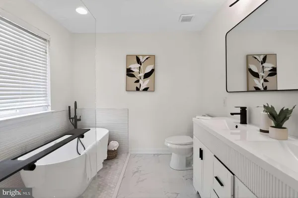 a bathroom with a toilet sink and mirror