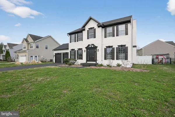 a front view of a house with a yard table and chairs