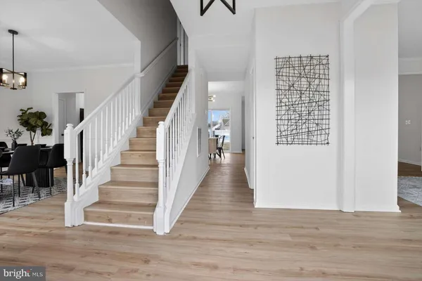 a view of entryway and hall with wooden floor