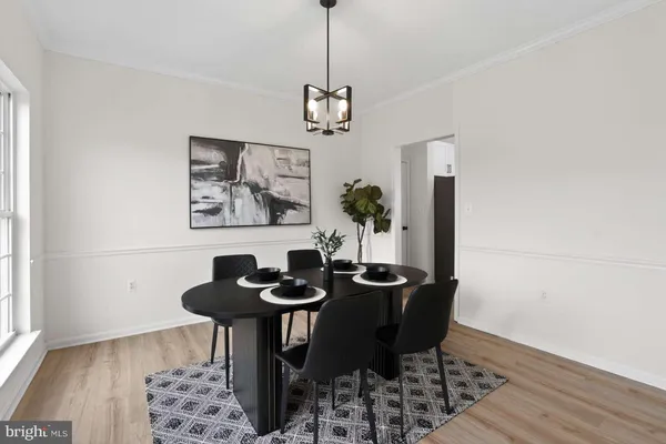 a dining room with furniture and wooden floor