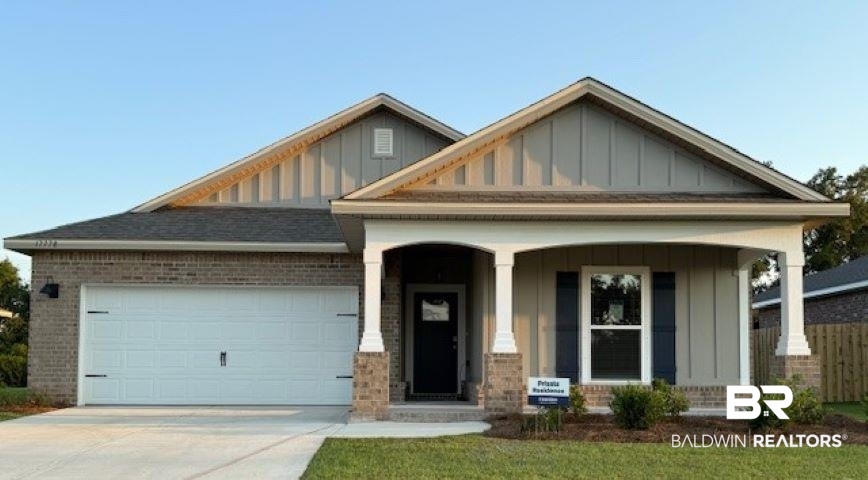 17778 Hens Avenue Foley, AL 36535 - Photo 1 of 38 Craftsman house with board and batten siding, a porch, concrete driveway, and brick siding