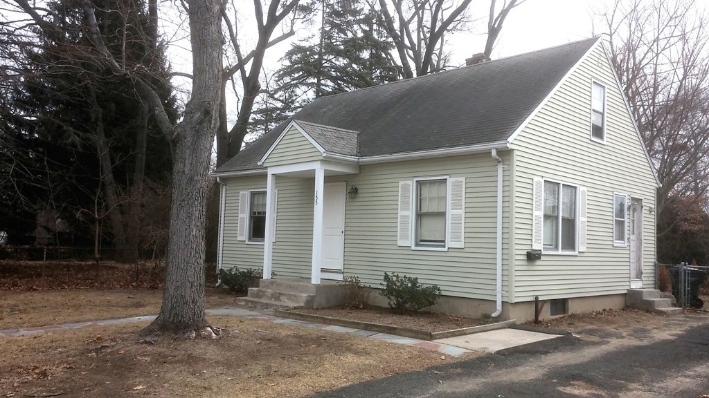 155 Carroll Street Springfield, MA 01108 - Photo 1 of 15 a front view of a house with a yard and garage