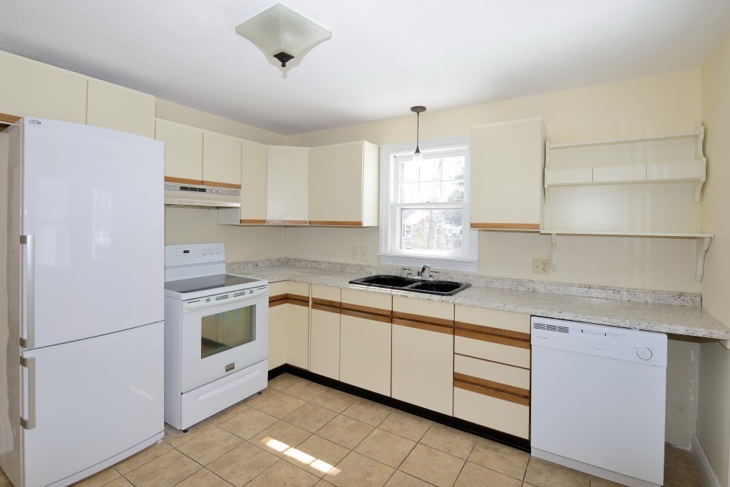 155 Carroll Street Springfield, MA 01108 - Photo 2 of 15 a kitchen with stainless steel appliances granite countertop a sink a stove a refrigerator and white cabinets
