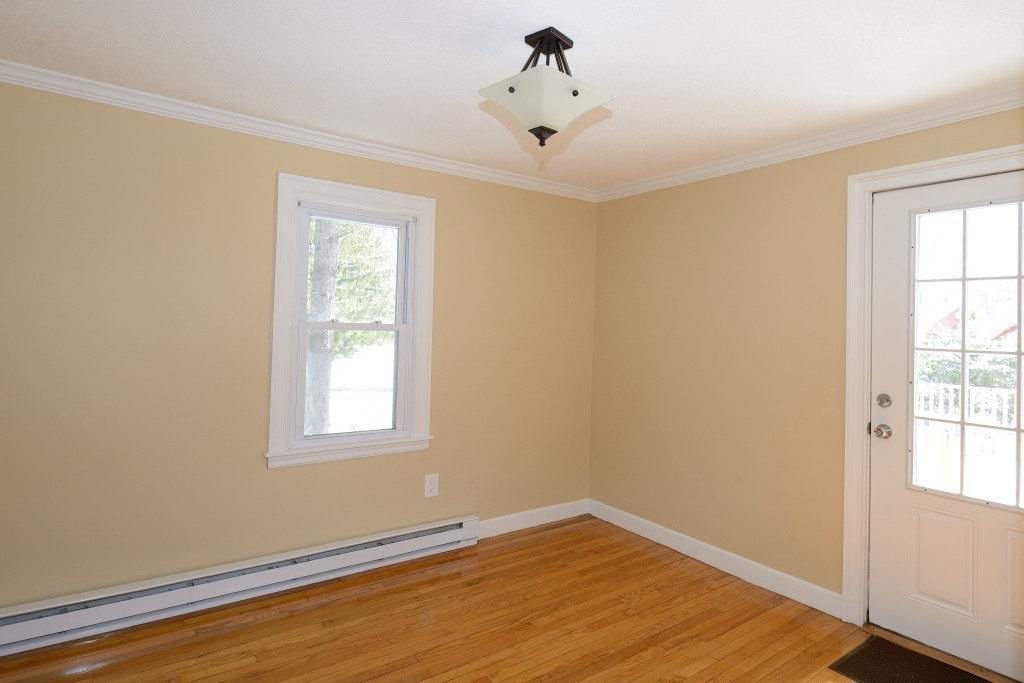 155 Carroll Street Springfield, MA 01108 - Photo 7 of 15 a view of an empty room with wooden floor and a window