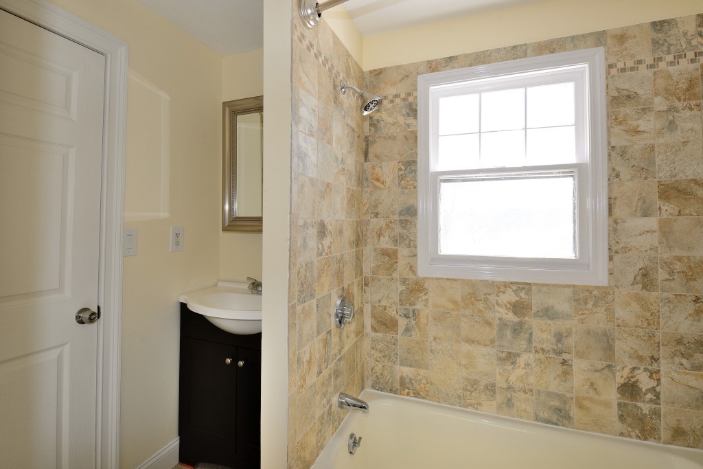 155 Carroll Street Springfield, MA 01108 - Photo 8 of 15 a bathroom with a bathtub and shower