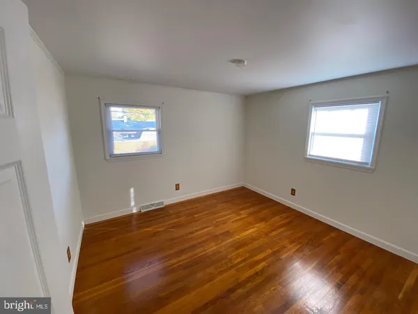 a view of a room with window and wooden floor