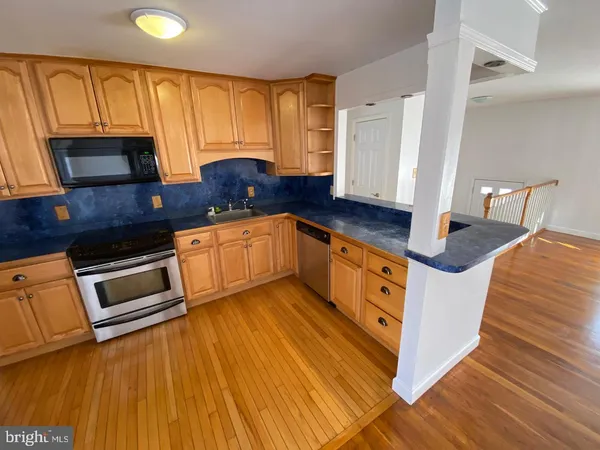 a kitchen with stainless steel appliances granite countertop a sink and cabinets