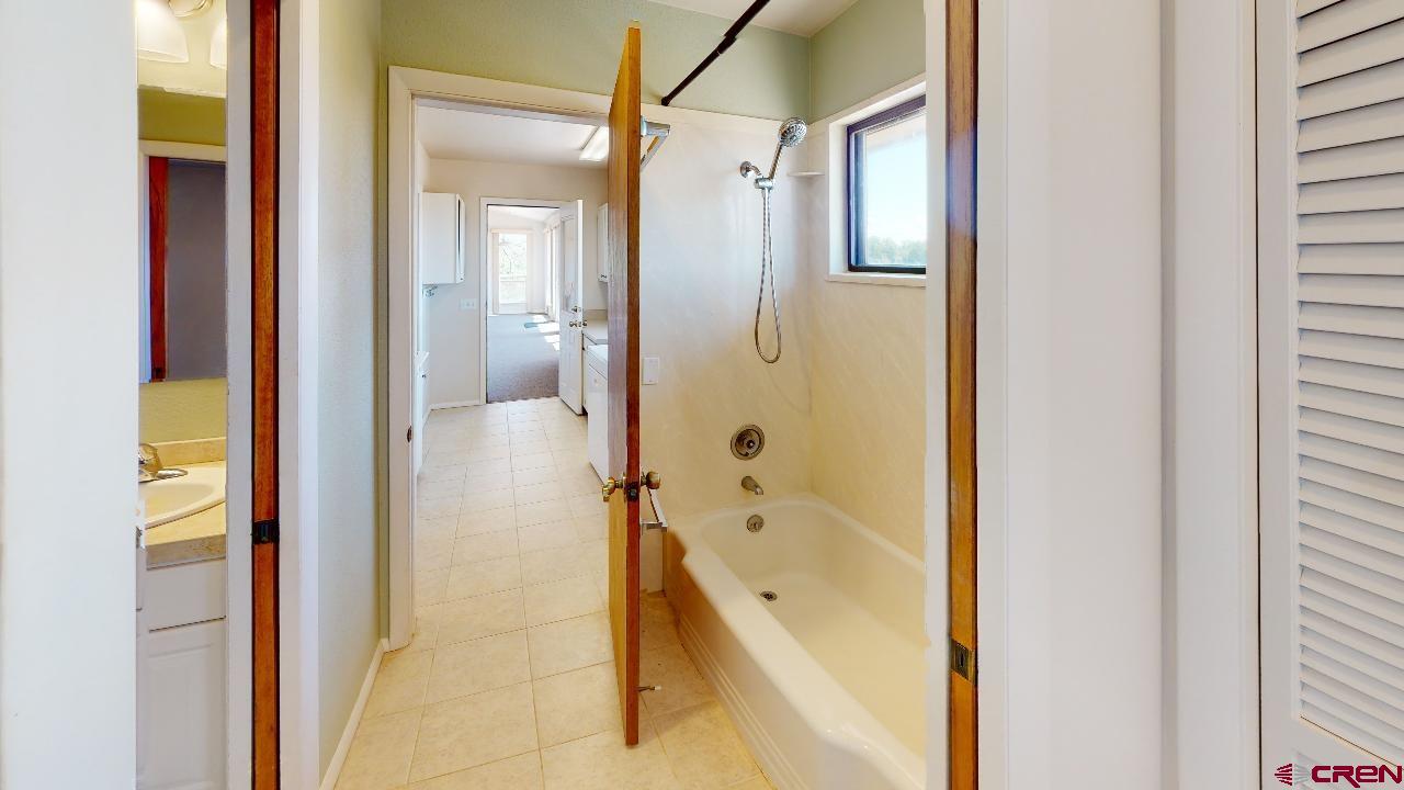 16407 Happy Hollow Road Cedaredge, CO 81413 - Photo 13 of 35 a bathroom with a tub