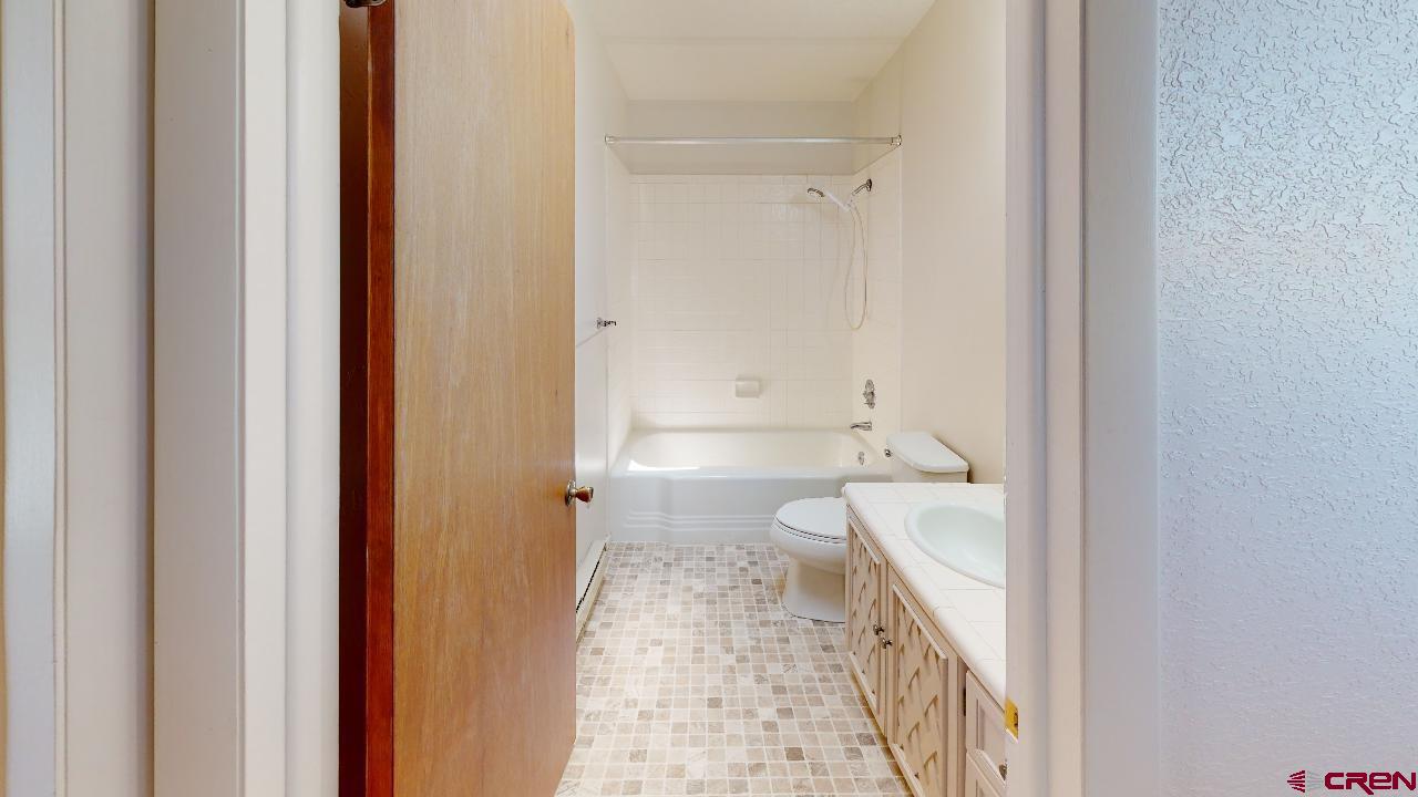 16407 Happy Hollow Road Cedaredge, CO 81413 - Photo 17 of 35 a bathroom with a tub