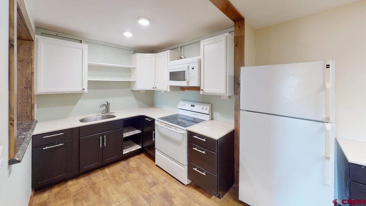16407 Happy Hollow Road Cedaredge, CO 81413 - Photo 23 of 35 a kitchen with stainless steel appliances a refrigerator sink and cabinets