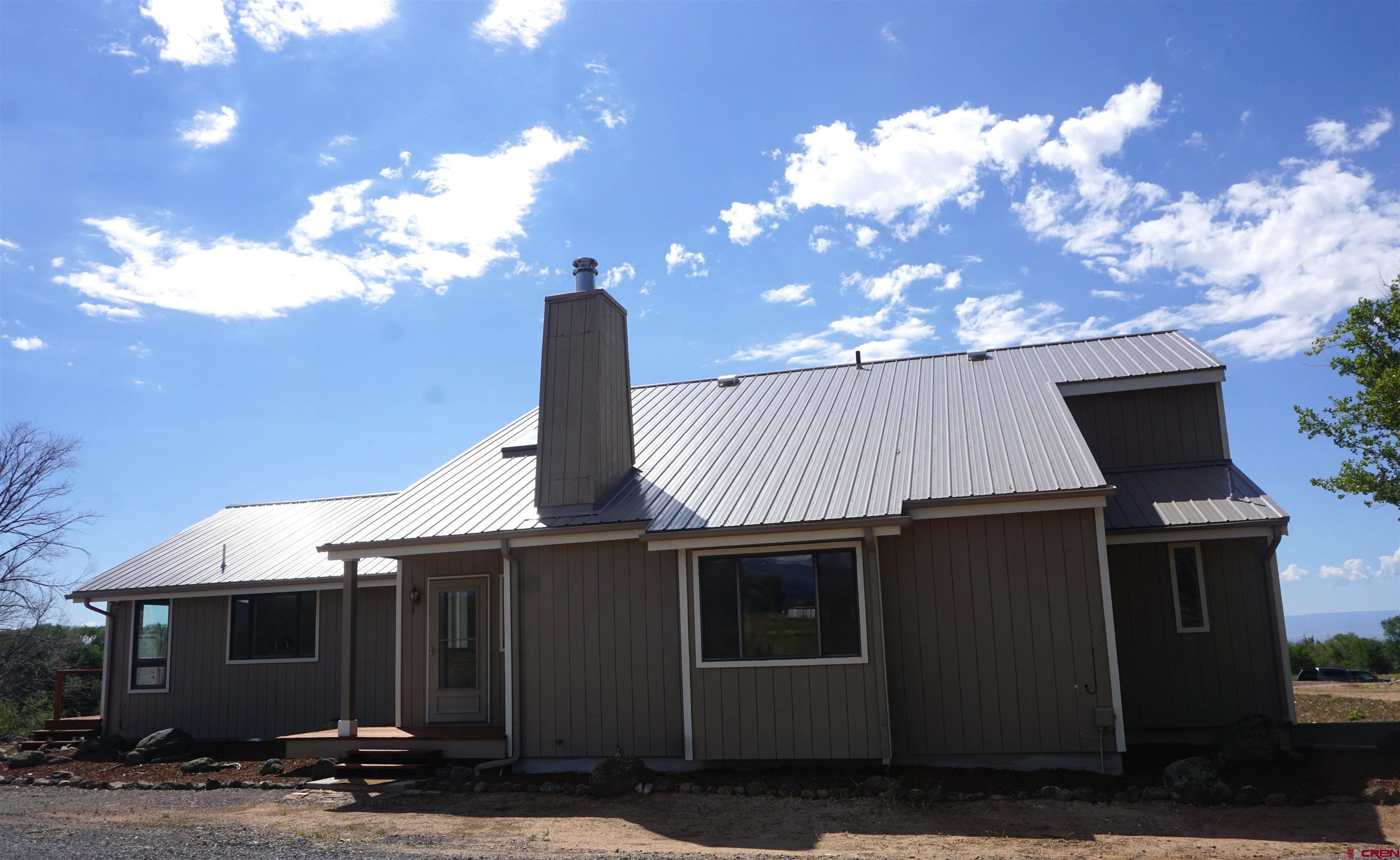 16407 Happy Hollow Road Cedaredge, CO 81413 - Photo 3 of 35 a view of a house with a yard