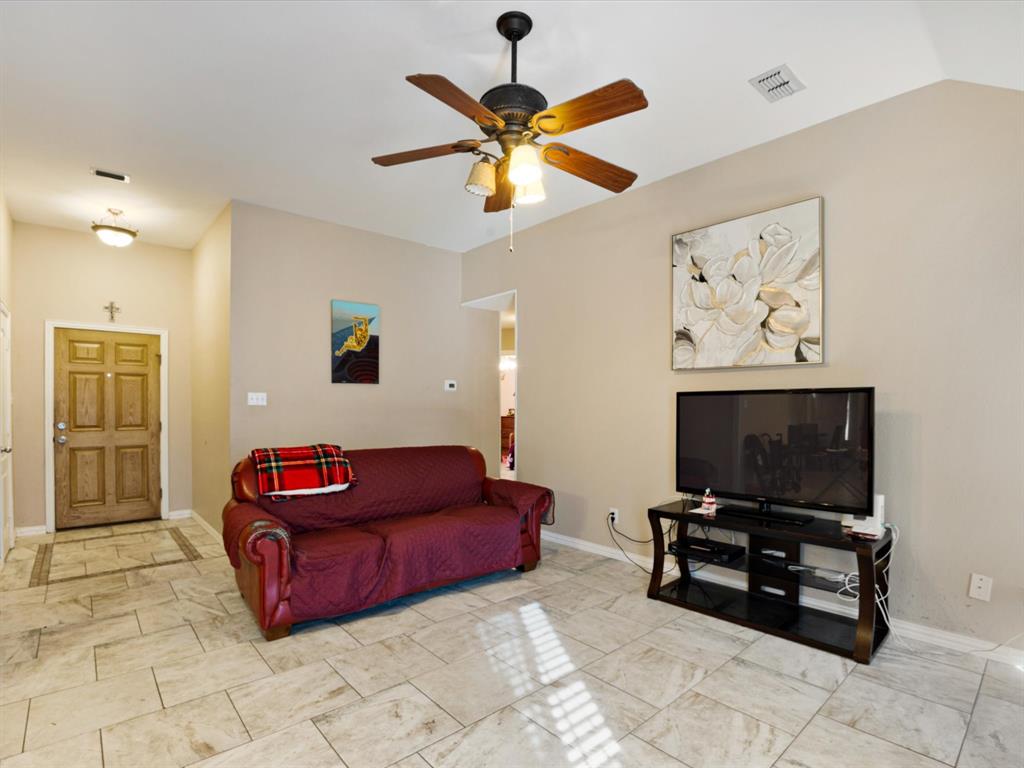 207 Quail Run Aubrey, TX 76227 - Photo 21 of 30 Living area featuring ceiling fan and baseboards
