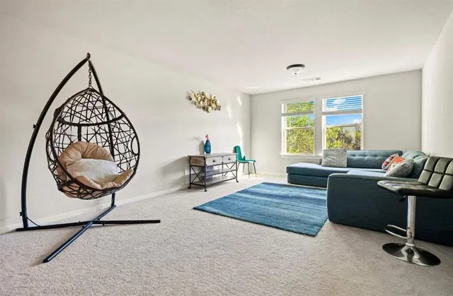 a living room with furniture a window and a chandelier