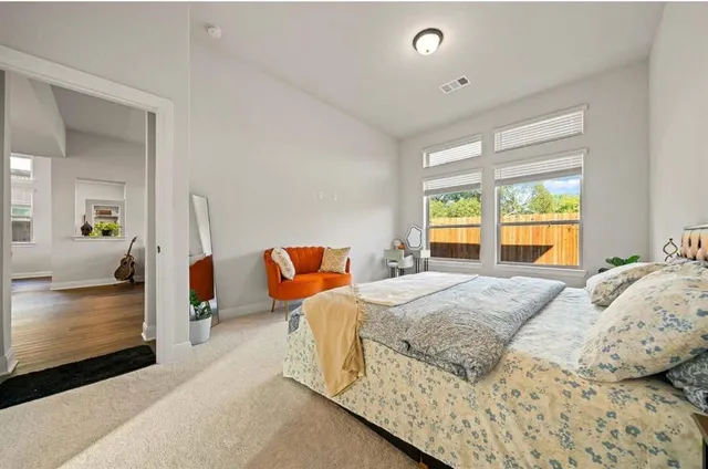 a bedroom with bed and window