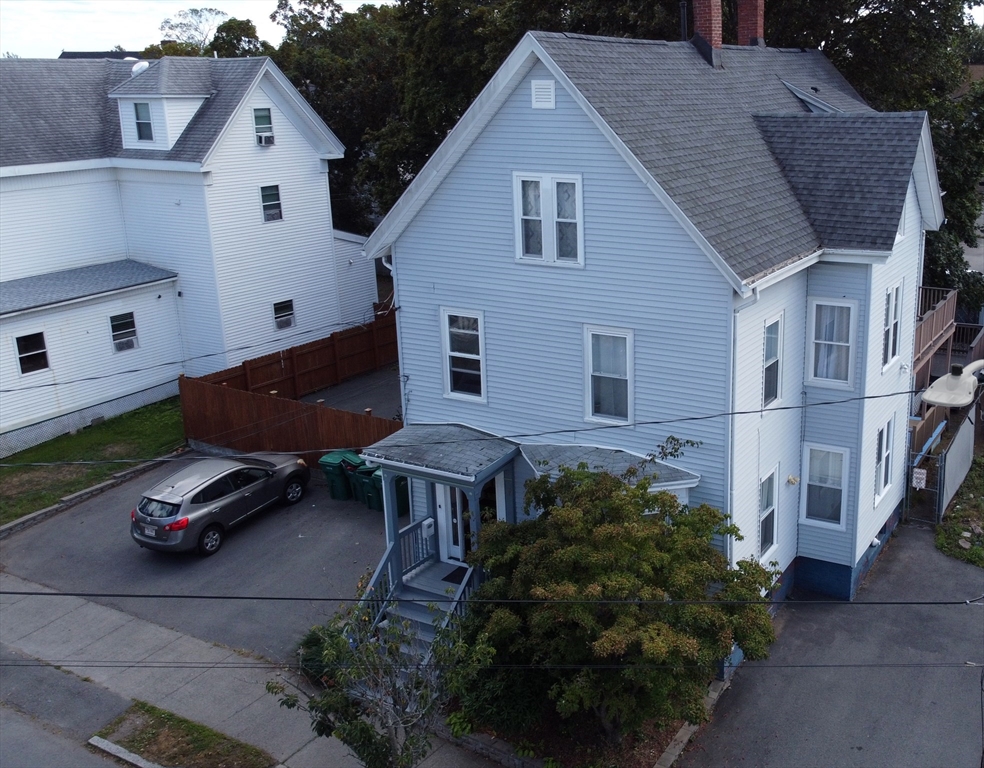 a aerial view of a house with table and chairs