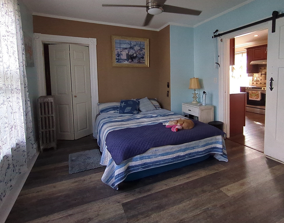 7 Cherry Street Lynn, MA 01902 - Photo 11 of 42 a bedroom with a bed and wooden floor