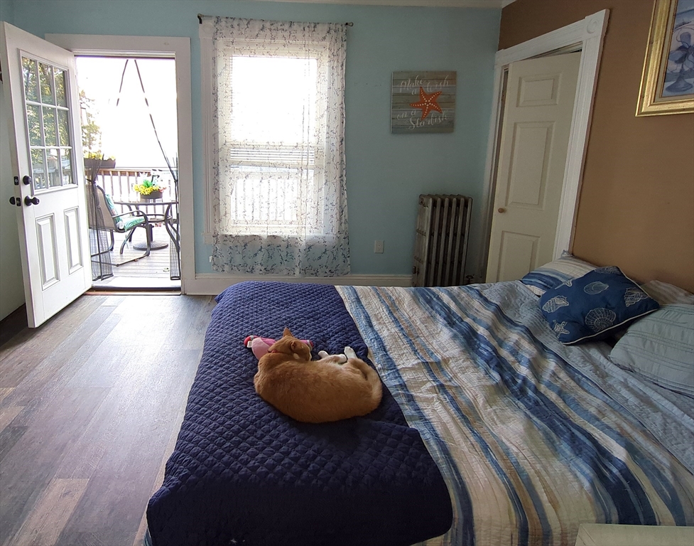 7 Cherry Street Lynn, MA 01902 - Photo 12 of 42 a bed sitting in a bedroom next to a window