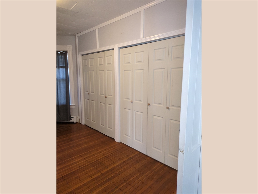 7 Cherry Street Lynn, MA 01902 - Photo 21 of 42 a view of an empty room with wooden floor and a window