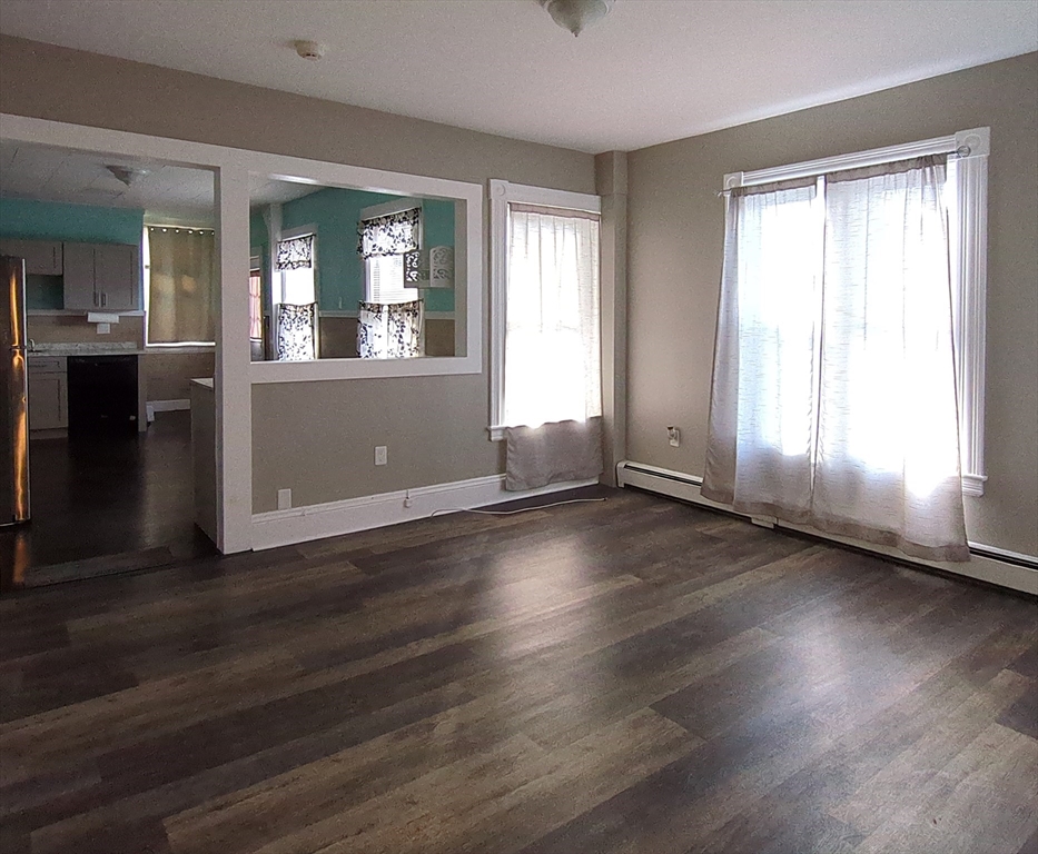 7 Cherry Street Lynn, MA 01902 - Photo 22 of 42 an empty room with wooden floor and windows